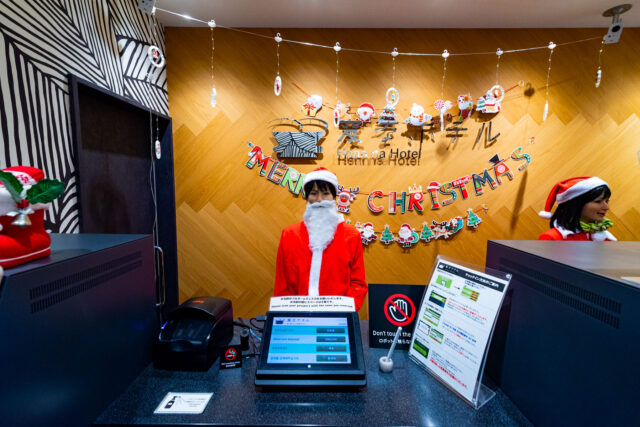 Festively decorated reception at Henn na Hotel in Tokyo Akasaka Japan, with robot staff dressed as Santa Claus during the Christmas season.