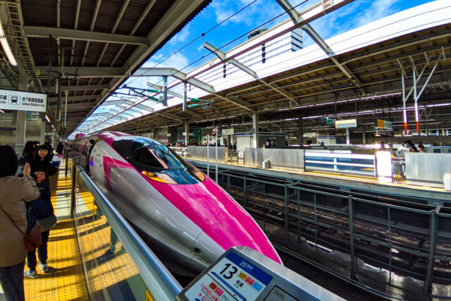 Pink and white Hello Kitty Shinkansen bullet train at the Shin-Osaka Station platform in Japan