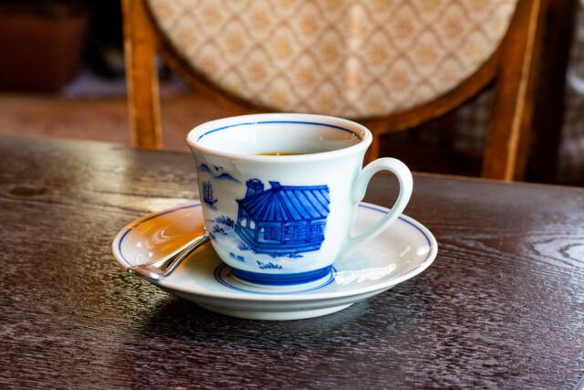A delicate porcelain teacup on a saucer, served at Jiyu-tei Café and Teahouse in Nagasaki’s Glover Garden.