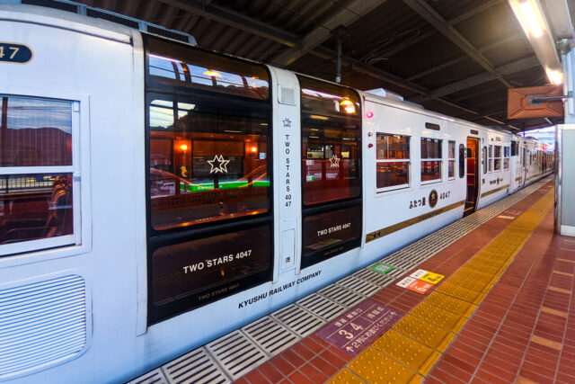 Exterior of the luxurious Two Stars 4047 regional train in Japan with large windows and elegant design.